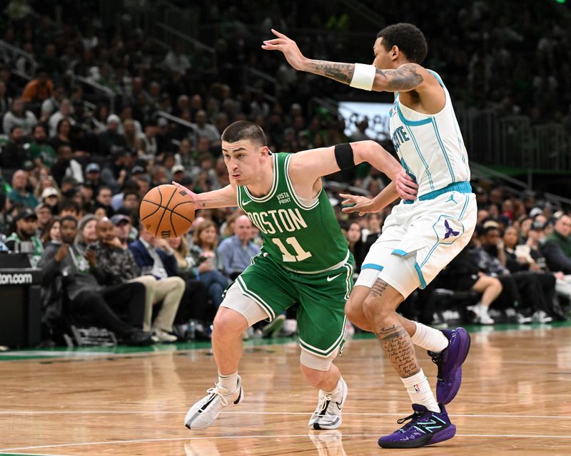 BOSTON, MASSACHUSETTS - APRIL 12: Payton Pritchard #11 of the Boston Celtics drives to the basket against Nick Smith Jr. #8 of the Charlotte Hornetsduring the first quarter at the TD Garden on April 12, 2024 in Boston, Massachusetts. NOTE TO USER: User expressly acknowledges and agrees that, by downloading and or using this photograph, User is consenting to the terms and conditions of the Getty Images License Agreement. (Photo by Brian Fluharty/Getty Images)