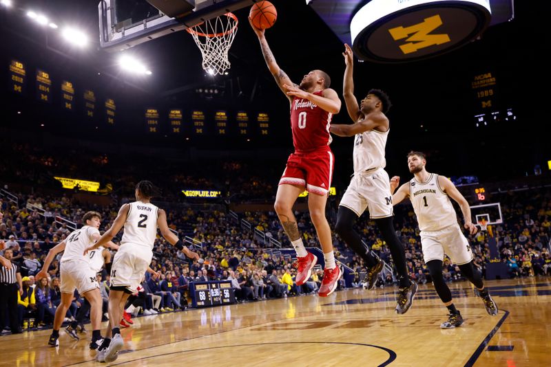 Feb 8, 2023; Ann Arbor, Michigan, USA;  Nebraska Cornhuskers guard C.J. Wilcher (0) shoots on Michigan Wolverines guard Jace Howard (25) in the second half at Crisler Center. Mandatory Credit: Rick Osentoski-USA TODAY Sports