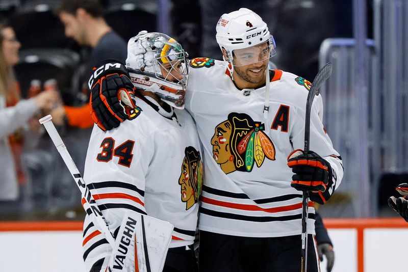 Oct 28, 2024; Denver, Colorado, USA; Chicago Blackhawks goaltender Petr Mrazek (34) and defenseman Seth Jones (4) celebrate after the game against the Colorado Avalanche at Ball Arena. Mandatory Credit: Isaiah J. Downing-Imagn Images