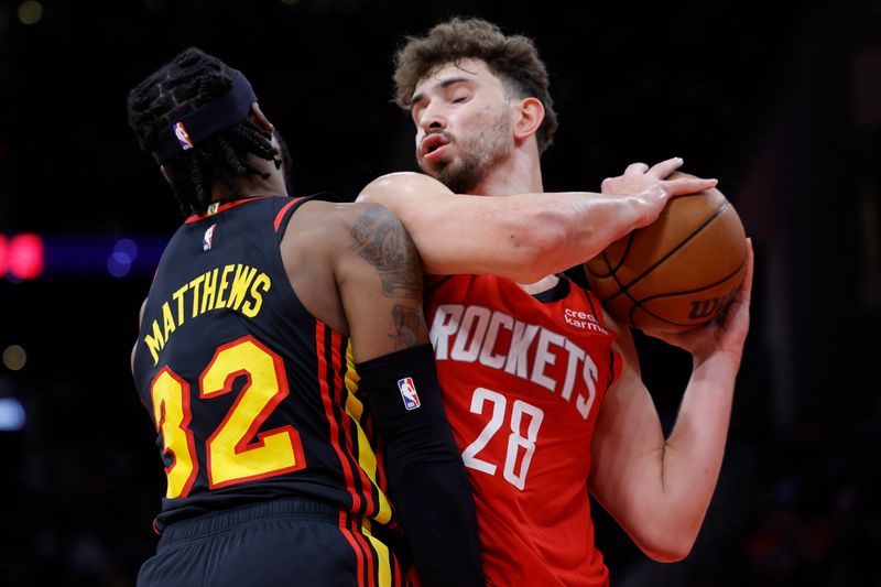 HOUSTON, TEXAS - DECEMBER 20: Alperen Sengun #28 of the Houston Rockets grabs a rebound against Wesley Matthews #32 of the Atlanta Hawks during the first half at Toyota Center on December 20, 2023 in Houston, Texas. User expressly acknowledges and agrees that, by downloading and or using this photograph, User is consenting to the terms and conditions of the Getty Images License Agreement.?  (Photo by Carmen Mandato/Getty Images)