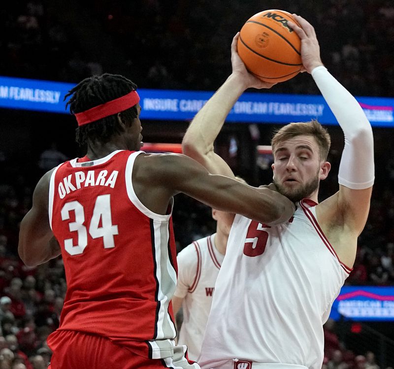 Feb 13, 2024; Madison, Wisconsin, USA;. Ohio State center Felix Okpara (34) grads Wisconsin forward Tyler Wahl (5) during the second half of their game at the Kohl Center. Mandatory Credit: Mark Hoffman/Milwaukee Journal Sentinelf-USA TODAY Sports
