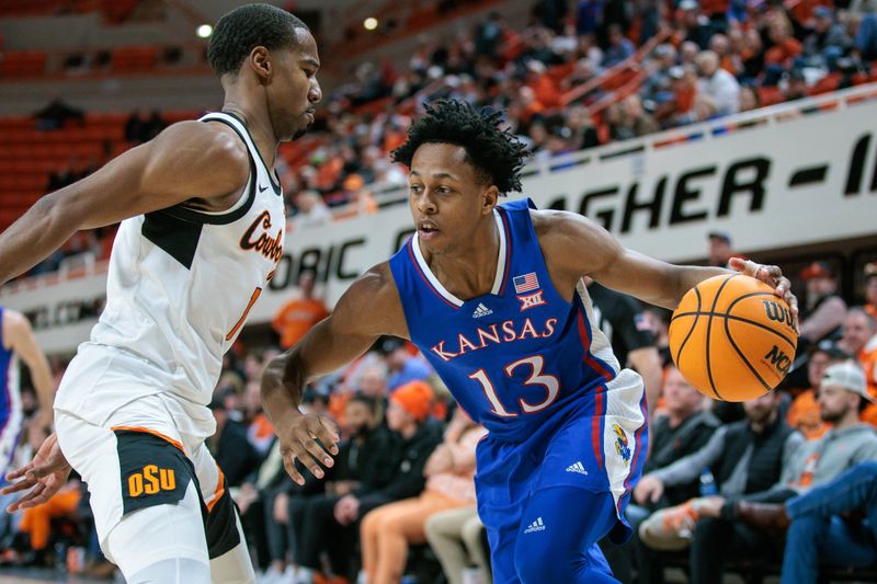 Jan 16, 2024; Stillwater, Oklahoma, USA; Kansas Jayhawks guard Charlie McCarthy (13) drives around Oklahoma State Cowboys guard Bryce Thompson (1) during the second half at Gallagher-Iba Arena. Mandatory Credit: William Purnell-USA TODAY Sports