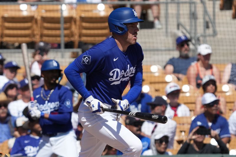 Mar 16, 2026; Phoenix, Arizona, USA; Los Angeles Dodgers first baseman Freddie Freeman (5) hits a single against the Milwaukee Brewers in the first inning at Camelback Ranch-Glendale. Mandatory Credit: Rick Scuteri-Imagn Images