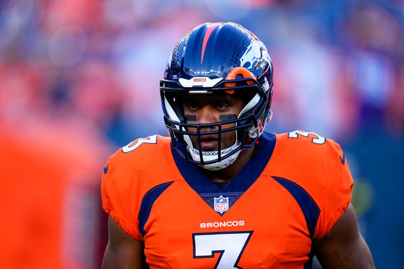 Denver Broncos quarterback Russell Wilson (3) warms up against the Minnesota Vikings during an NFL preseason football game, Saturday, Aug. 27, 2022, in Denver. (AP Photo/Jack Dempsey)