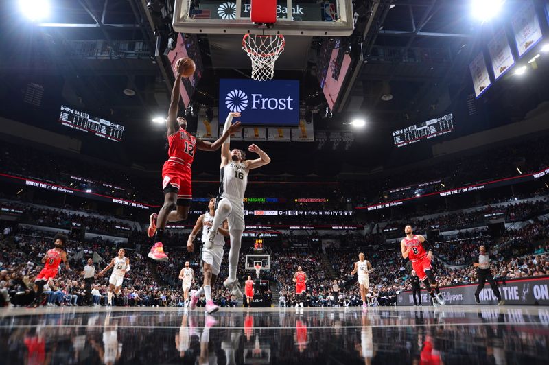 SAN ANTONIO, TX - JANUARY 13: Ayo Dosunmu #12 of the Chicago Bulls drives to the basket during the game against the San Antonio Spurs on January 13, 2024 at the Frost Bank Center in San Antonio, Texas. NOTE TO USER: User expressly acknowledges and agrees that, by downloading and or using this photograph, user is consenting to the terms and conditions of the Getty Images License Agreement. Mandatory Copyright Notice: Copyright 2024 NBAE (Photos by Michael Gonzales/NBAE via Getty Images)