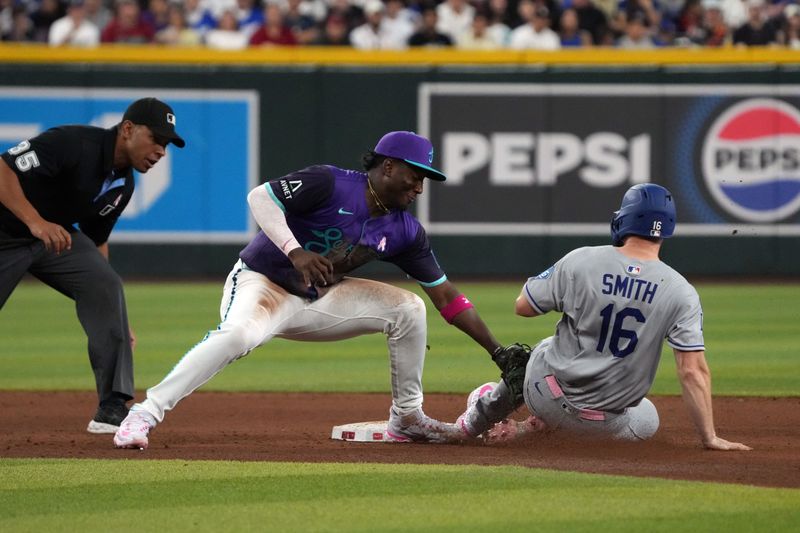May 11, 2025; Phoenix, Arizona, USA; Arizona Diamondbacks shortstop Geraldo Perdomo (2) tags out Los Angeles Dodgers catcher Will Smith (16) while he was trying to steal in the fifth inning at Chase Field. Mandatory Credit: Rick Scuteri-Imagn Images