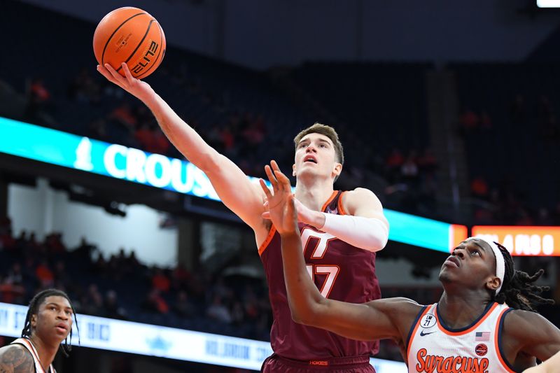 Jan 21, 2026; Syracuse, New York, USA; Virginia Tech Hokies guard Neoklis Avdalas (17) shoots against Syracuse Orange forward William Kyle III (right) during the first half at the JMA Wireless Dome. Mandatory Credit: Rich Barnes-Imagn Images