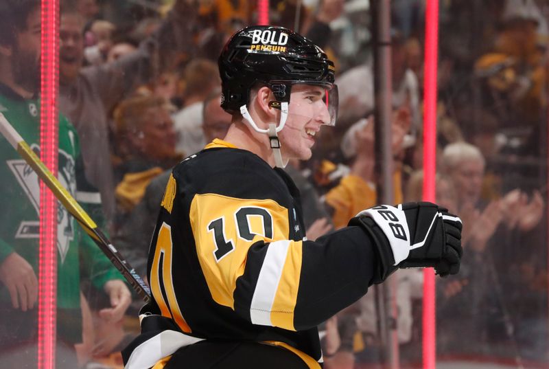 Oct 18, 2024; Pittsburgh, Pennsylvania, USA;  Pittsburgh Penguins left wing Drew O'Connor (10) reacts after scoring a goal against the Carolina Hurricanes during the first period at PPG Paints Arena. Mandatory Credit: Charles LeClaire-Imagn Images