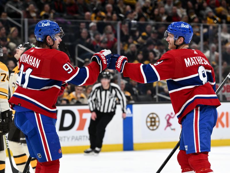 Jan 20, 2024; Boston, Massachusetts, USA; Montreal Canadiens defenseman Mike Matheson (8) high-fives Montreal Canadiens center Sean Monahan (91) after scoring a goal against the Boston Bruins during the second period at the TD Garden. Mandatory Credit: Brian Fluharty-USA TODAY Sports