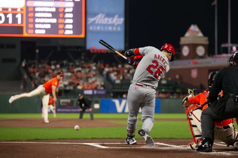 Sep 27, 2024; San Francisco, California, USA; St. Louis Cardinals third baseman Nolan Arenado (28) hits an RBI single off San Francisco Giants starting pitcher Landen Roupp (65) during the first inning at Oracle Park. Mandatory Credit: D. Ross Cameron-Imagn Images