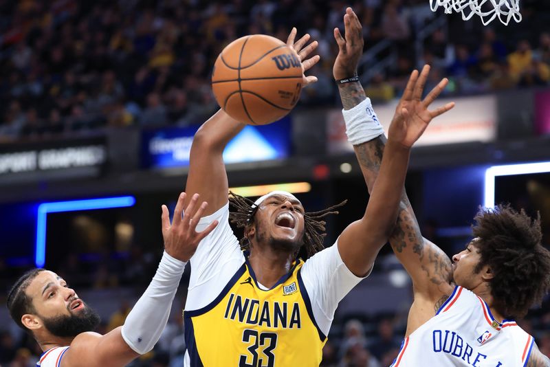 INDIANAPOLIS, INDIANA - OCTOBER 27: Myles Turner #33 of the Indiana Pacers battles for the ball against Caleb Martin #16 and Kelly Oubre Jr. #9 of the Philadelphia 76ers in overtime at Gainbridge Fieldhouse on October 27, 2024 in Indianapolis, Indiana. NOTE TO USER: User expressly acknowledges and agrees that, by downloading and or using this photograph, User is consenting to the terms and conditions of the Getty Images License Agreement. (Photo by Justin Casterline/Getty Images)