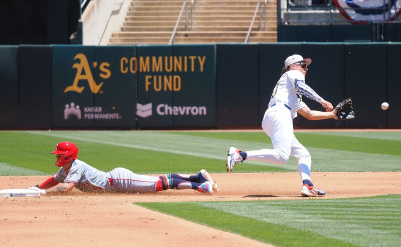 Jul 4, 2024; Oakland, California, USA; Los Angeles Angels shortstop Zach Neto (9) steals second base against Oakland Athletics second baseman Zack Gelof (20) during the third inning at Oakland-Alameda County Coliseum. Mandatory Credit: Kelley L Cox-USA TODAY Sports