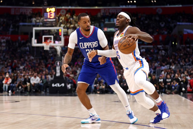 LOS ANGELES, CALIFORNIA - JANUARY 16: Luguentz Dort #5 of the Oklahoma City Thunder drives to the basket against Norman Powell #24 of the Los Angeles Clippers during the fourth quarter at Crypto.com Arena on January 16, 2024 in Los Angeles, California. NOTE TO USER: User expressly acknowledges and agrees that, by downloading and or using this photograph, User is consenting to the terms and conditions of the Getty Images License Agreement. (Photo by Katelyn Mulcahy/Getty Images)