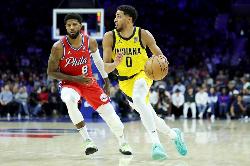 PHILADELPHIA, PENNSYLVANIA - DECEMBER 13: Tyrese Haliburton #0 of the Indiana Pacers drives to the basket against Paul George #8 of the Philadelphia 76ers during the first half at the Wells Fargo Center on December 13, 2024 in Philadelphia, Pennsylvania. NOTE TO USER: User expressly acknowledges and agrees that, by downloading and or using this photograph, User is consenting to the terms and conditions of the Getty Images License Agreement. (Photo by Emilee Chinn/Getty Images)