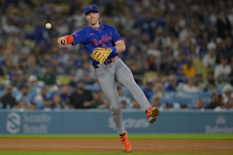 Jun 4, 2025; Los Angeles, California, USA; New York Mets third baseman Brett Baty (7) throws out Los Angeles Dodgers shortstop Mookie Betts (50) at first base in the eighth inning at Dodger Stadium. Mandatory Credit: Jayne Kamin-Oncea-Imagn Images