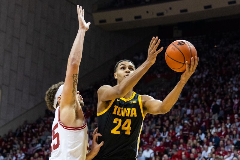 Feb 28, 2023; Bloomington, Indiana, USA; Iowa Hawkeyes forward Kris Murray (24) shoots the ball while Indiana Hoosiers forward Race Thompson (25) defends in the second half at Simon Skjodt Assembly Hall. Mandatory Credit: Trevor Ruszkowski-USA TODAY Sports