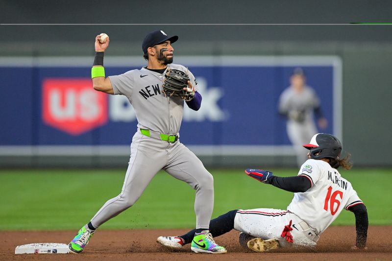 Sep 17, 2025; Minneapolis, Minnesota, USA;  New York Yankees infielder Jose Caballero (72) throws over Minnesota Twins outfielder Austin Martin (16) to complete a double play during the first inning at Target Field. Mandatory Credit: Nick Wosika-Imagn Images

