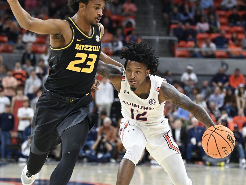 Feb 14, 2023; Auburn, Alabama, USA;  Auburn Tigers guard Zep Jasper (12) drives past Missouri Tigers forward Aidan Shaw (23) during the second half at Neville Arena. Mandatory Credit: Julie Bennett-USA TODAY Sports
