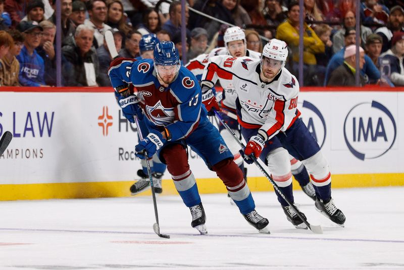 Nov 15, 2024; Denver, Colorado, USA; Colorado Avalanche right wing Valeri Nichushkin (13) controls the puck ahead of Washington Capitals left wing Pierre-Luc Dubois (80) in the second period at Ball Arena. Mandatory Credit: Isaiah J. Downing-Imagn Images