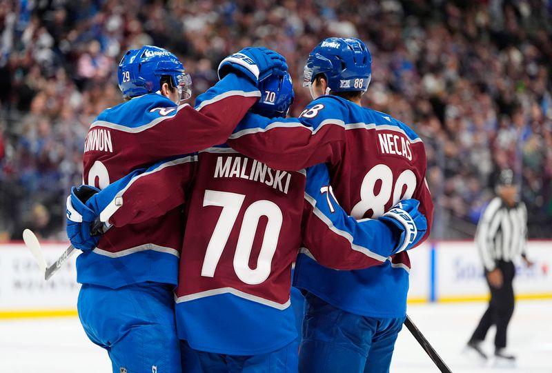 Nov 26, 2025; Denver, Colorado, USA; Colorado Avalanche defenseman Sam Malinski (70) celebrates his goal with center Nathan MacKinnon (29) and center Martin Necas (88) during the second period against the San Jose Sharks at Ball Arena. Mandatory Credit: Ron Chenoy-Imagn Images