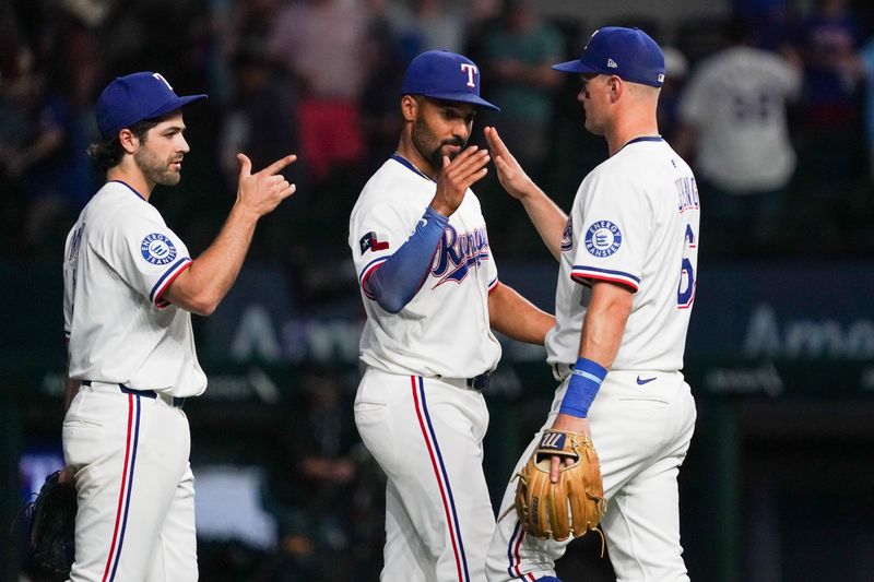 May 13, 2025; Arlington, Texas, USA; Texas Rangers outfielder Josh Smith (8) and second baseman Marcus Semien (2) high five third baseman Josh Jung (6) after the game against the Colorado Rockies at Globe Life Field. Mandatory Credit: Raymond Carlin III-Imagn Images