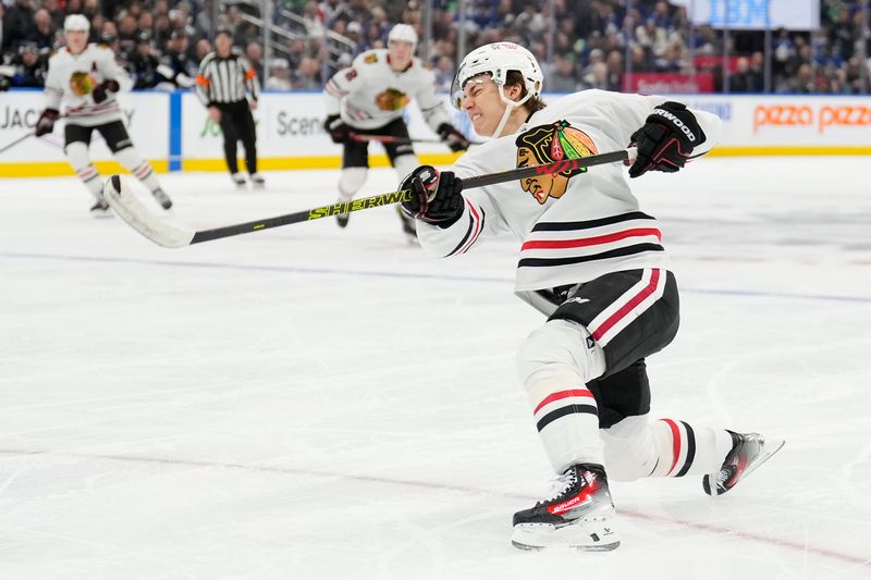 Dec 2, 2024; Toronto, Ontario, CAN; Chicago Blackhawks forward Connor Bedard (98) shoots the puck against the Toronto Maple Leafs during the second period at Scotiabank Arena. Mandatory Credit: John E. Sokolowski-Imagn Images