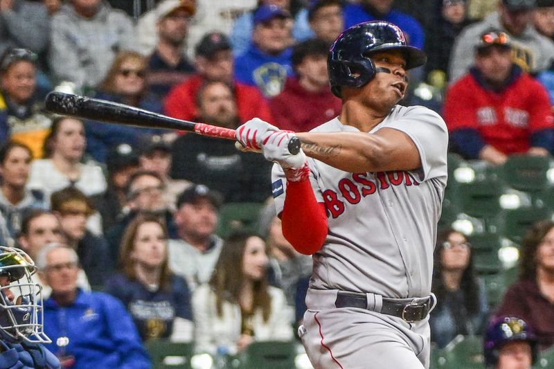 Apr 22, 2023; Milwaukee, Wisconsin, USA; Boston Red Sox third baseman Rafael Devers (11) hits a 2-run home run in the sixth inning during game against the Milwaukee Brewers at American Family Field. Mandatory Credit: Benny Sieu-USA TODAY Sports