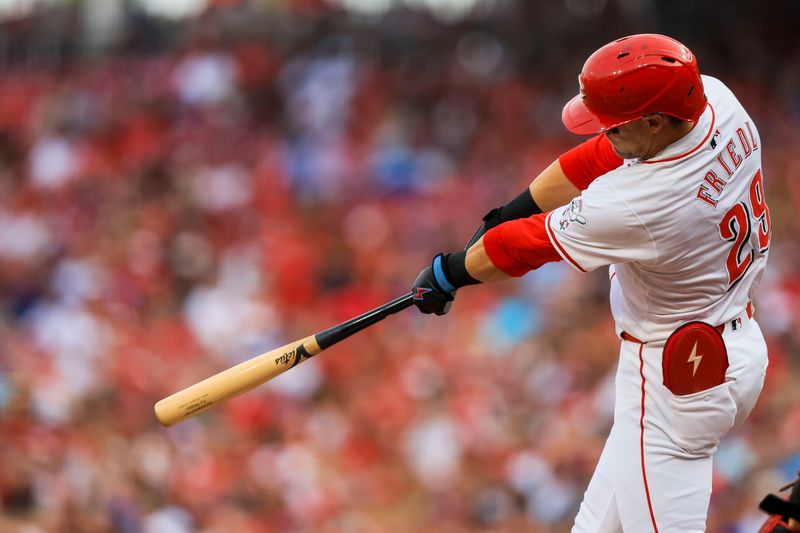 Jul 30, 2024; Cincinnati, Ohio, USA; Cincinnati Reds outfielder TJ Friedl (29) hits a two-run single in the first inning against the Chicago Cubs at Great American Ball Park. Mandatory Credit: Katie Stratman-USA TODAY Sports