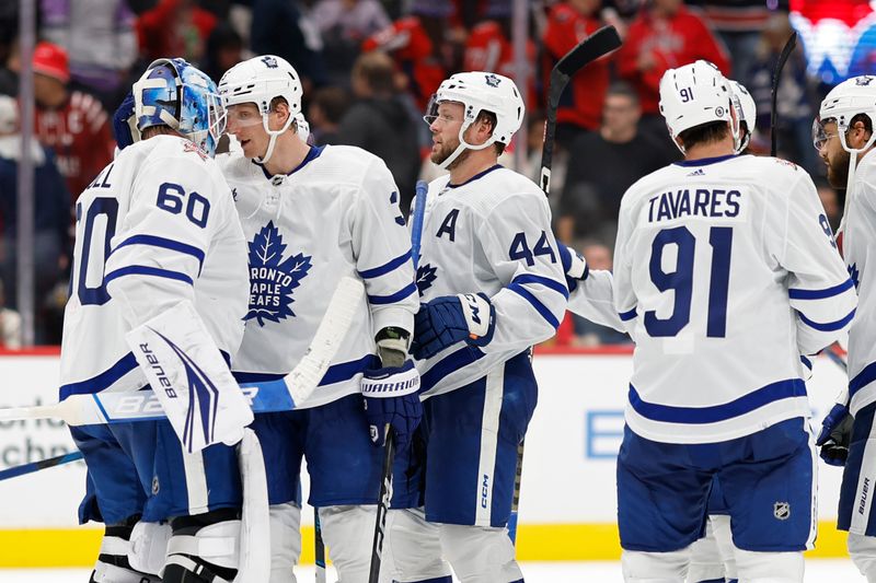 Oct 24, 2023; Washington, District of Columbia, USA; Toronto Maple Leafs goaltender Joseph Woll (60) celebrates with Maple Leafs defenseman John Klingberg (3) after their game against the Washington Capitals at Capital One Arena. Mandatory Credit: Geoff Burke-USA TODAY Sports