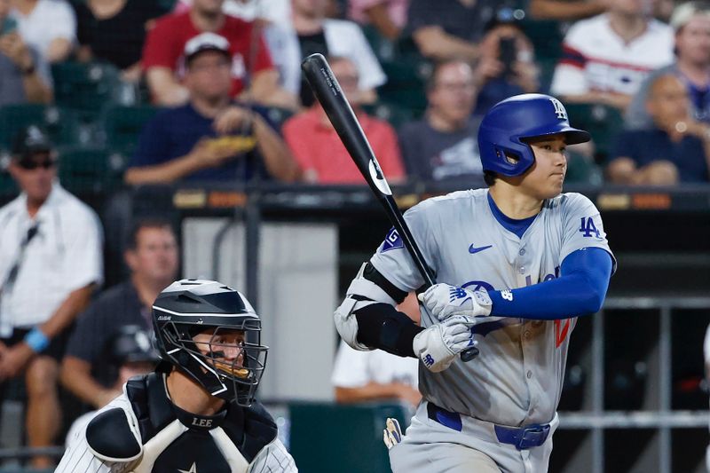 Jun 25, 2024; Chicago, Illinois, USA; Los Angeles Dodgers designated hitter Shohei Ohtani (17) hits an RBI-single against the Chicago White Sox during the fourth inning at Guaranteed Rate Field. Mandatory Credit: Kamil Krzaczynski-USA TODAY Sports