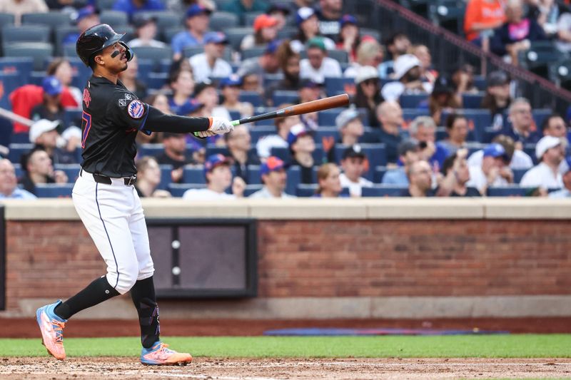 Jul 12, 2024; New York City, New York, USA;  New York Mets third baseman Mark Vientos (27) hits a solo home run in the second inning against the Colorado Rockies at Citi Field. Mandatory Credit: Wendell Cruz-USA TODAY Sports