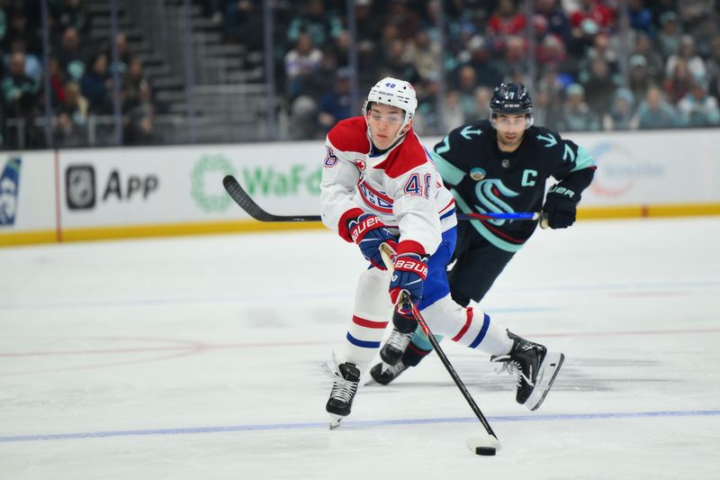 Oct 28, 2025; Seattle, Washington, USA; Montreal Canadiens defenseman Lane Hutson (48) plays the puck during the first period against the Seattle Kraken at Climate Pledge Arena. Mandatory Credit: Steven Bisig-Imagn Images