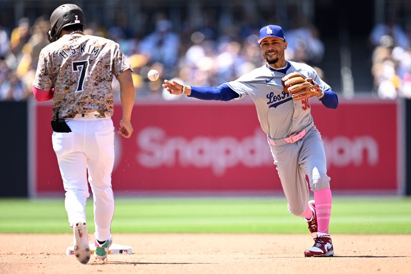 May 12, 2024; San Diego, California, USA; Los Angeles Dodgers shortstop Mookie Betts (50) throws to first base late after forcing out San Diego Padres shortstop Ha-Seong Kim (7) at second base during the fourth inning at Petco Park. Mandatory Credit: Orlando Ramirez-USA TODAY Sports