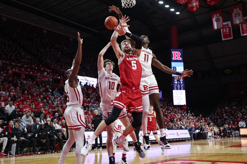 Feb 10, 2024; Piscataway, New Jersey, USA; Rutgers Scarlet Knights center Clifford Omoruyi (11) blocks a shot by Wisconsin Badgers forward Tyler Wahl (5) during the first half at Jersey Mike's Arena. Mandatory Credit: Vincent Carchietta-USA TODAY Sports