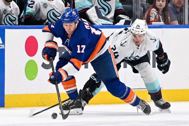 Feb 13, 2024; Elmont, New York, USA; New York Islanders left wing Matt Martin (17) skates with the puck defended by Seattle Kraken defenseman Jamie Oleksiak (24) during the second period at UBS Arena. Mandatory Credit: Dennis Schneidler-USA TODAY Sports