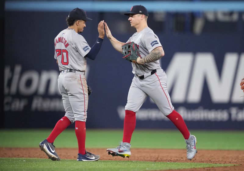 Jun 19, 2024; Toronto, Ontario, CAN;Boston Red Sox right fielder Tyler O'Neill (17) celebrates the win with Boston shortstop David Hamilton (70) against the Toronto Blue Jays at the end of the ninth inning at Rogers Centre. Mandatory Credit: Nick Turchiaro-USA TODAY Sports