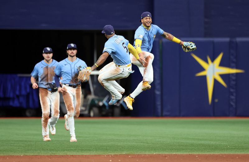 May 28, 2023; St. Petersburg, Florida, USA; Tampa Bay Rays center fielder Jose Siri (22), shortstop Wander Franco (5) and teammates celebrate as they beat the Los Angeles Dodgers at Tropicana Field. Mandatory Credit: Kim Klement-USA TODAY Sports