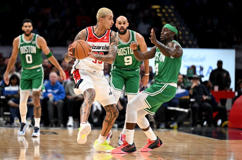 WASHINGTON, DC - OCTOBER 30: Kyle Kuzma #33 of the Washington Wizards handles the ball in the first quarter against Jrue Holiday #4 of the Boston Celtics at Capital One Arena on October 30, 2023 in Washington, DC.  NOTE TO USER: User expressly acknowledges and agrees that, by downloading and or using this photograph, User is consenting to the terms and conditions of the Getty Images License Agreement.  (Photo by Greg Fiume/Getty Images)