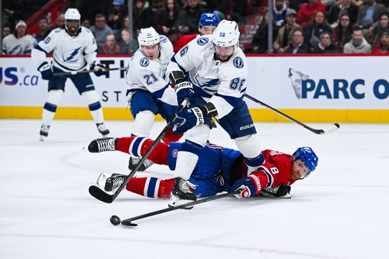 Apr 4, 2024; Montreal, Quebec, CAN; Montreal Canadiens defenseman Mike Matheson (8) defends the puck as he slides on the ice against Tampa Bay Lightning right wing Nikita Kucherov (86) during the second period at Bell Centre. Mandatory Credit: David Kirouac-USA TODAY Sports