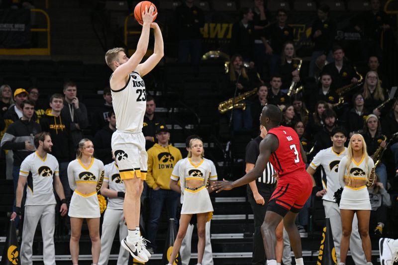 Jan 6, 2024; Iowa City, Iowa, USA; Iowa Hawkeyes forward Ben Krikke (23) shoots the ball over Rutgers Scarlet Knights forward Mawot Mag (3) during the first half at Carver-Hawkeye Arena. Mandatory Credit: Jeffrey Becker-USA TODAY Sports