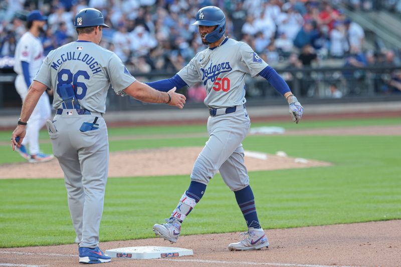 May 28, 2024; New York, NY, USA; Los Angeles Dodgers shortstop Mookie Betts (50) celebrates with first base coach Clayton McCullough (86) after an RBI single during the tenth inning against the New York Mets at Citi Field. Mandatory Credit: Vincent Carchietta-USA TODAY Sports