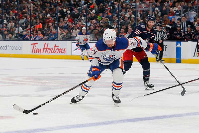 Mar 7, 2024; Columbus, Ohio, USA; Edmonton Oilers defenseman Brett Kulak (27) carries the puck against the Columbus Blue Jackets during the second period at Nationwide Arena. Mandatory Credit: Russell LaBounty-USA TODAY Sports