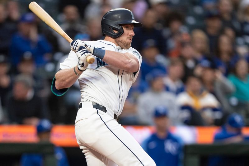 May 13, 2024; Seattle, Washington, USA; Seattle Mariners left fielder Luke Raley (20) hits a RBI-single during the third inning against the Kansas City Royals at T-Mobile Park. Mandatory Credit: Stephen Brashear-USA TODAY Sports