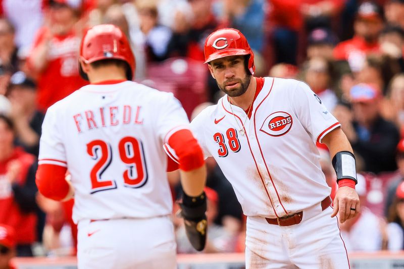 Apr 13, 2025; Cincinnati, Ohio, USA; Cincinnati Reds catcher Austin Wynns (38) high fives outfielder TJ Friedl (29) after scoring on a two-run single hit by second baseman Santiago Espinal (4) in the third inning against the Pittsburgh Pirates at Great American Ball Park. Mandatory Credit: Katie Stratman-Imagn Images