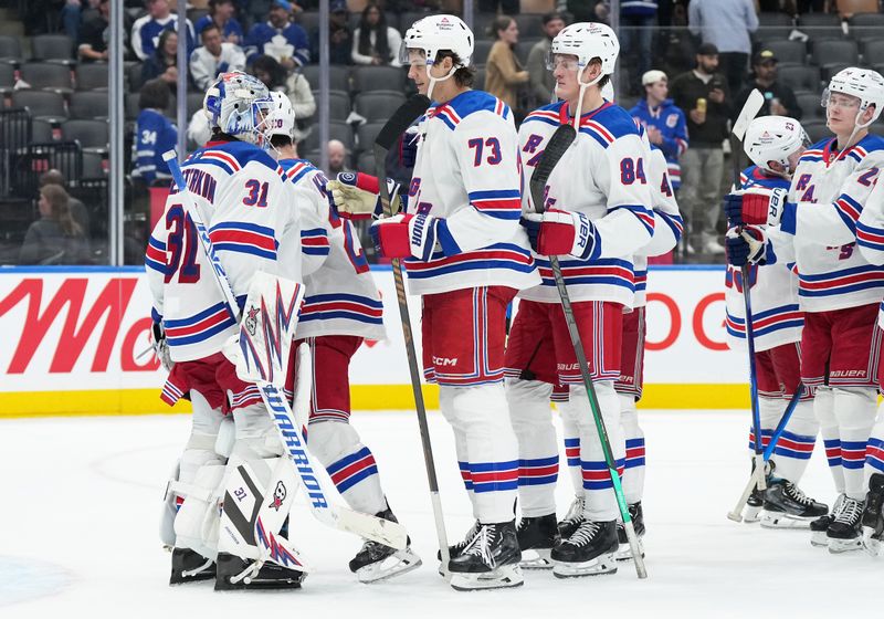 Oct 19, 2024; Toronto, Ontario, CAN; New York Rangers goaltender Igor Shesterkin (31) celebrates with center Matt Rempe (73) after defeating the Toronto Maple Leafs at Scotiabank Arena. Mandatory Credit: Nick Turchiaro-Imagn Images