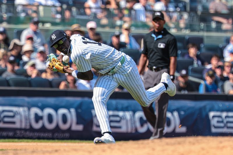 Aug 11, 2024; Bronx, New York, USA; New York Yankees third baseman Jazz Chisholm Jr. (13) can not field the ball during the seventh inning against the Texas Rangers  at Yankee Stadium. Mandatory Credit: Vincent Carchietta-USA TODAY Sports