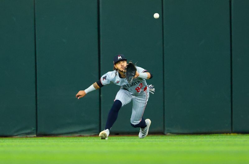 Aug 17, 2024; Arlington, Texas, USA;  Minnesota Twins center fielder Austin Martin (82) makes a catch during the first inning against the Texas Rangers at Globe Life Field. Mandatory Credit: Kevin Jairaj-USA TODAY Sports