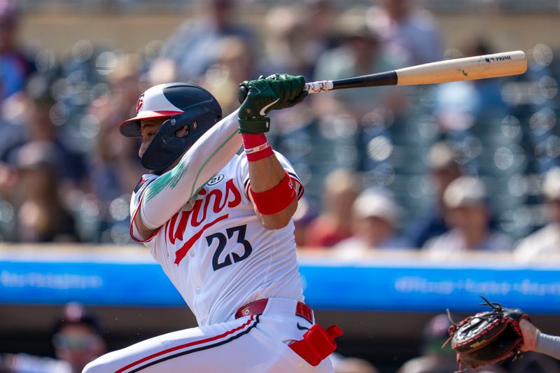 Sep 15, 2024; Minneapolis, Minnesota, USA; Minnesota Twins third baseman Royce Lewis (23) hits a single against the Cincinnati Reds in the first inning at Target Field. Mandatory Credit: Jesse Johnson-Imagn Images