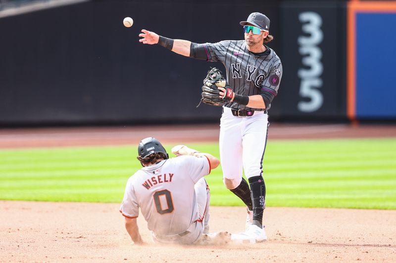 May 25, 2024; New York City, New York, USA;  New York Mets second baseman Jeff McNeil (1) throws past San Francisco Giants shotstop Brett Wisely (0) attempting to complete a double play in the eighth inning at Citi Field. Mandatory Credit: Wendell Cruz-USA TODAY Sports