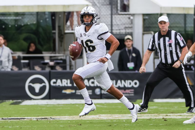 Nov 6, 2021; Orlando, Florida, USA; UCF Knights quarterback Mikey Keene (16) runs the ball during the first quarter against the Tulane Green Wave at Bounce House. Mandatory Credit: Mike Watters-USA TODAY Sports